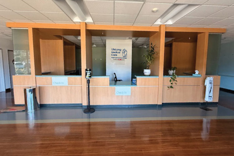 New Brookside Towne Center reception area with multiple check-in windows, wood counters, and a clean waiting space.